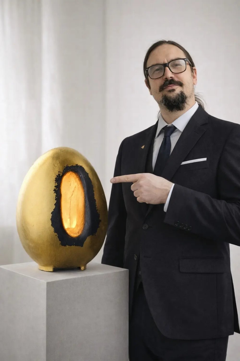 The maker of AIHIO in the Savonlinna studio with a finished sculptural lighting piece.